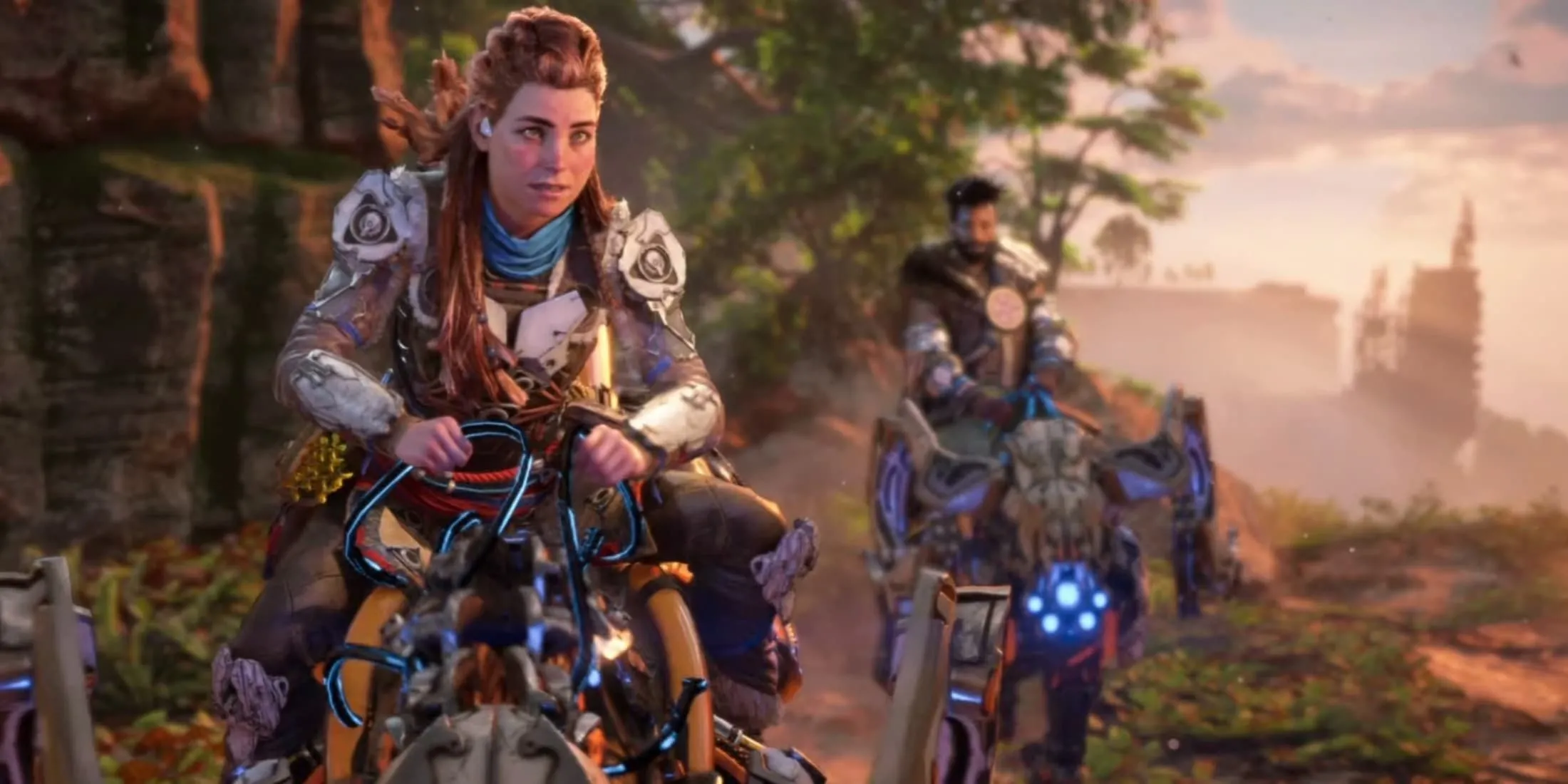 Aloy, nữ chính của Horizon Forbidden West, cưỡi thú máy cùng một nhân vật khác ở phía sau