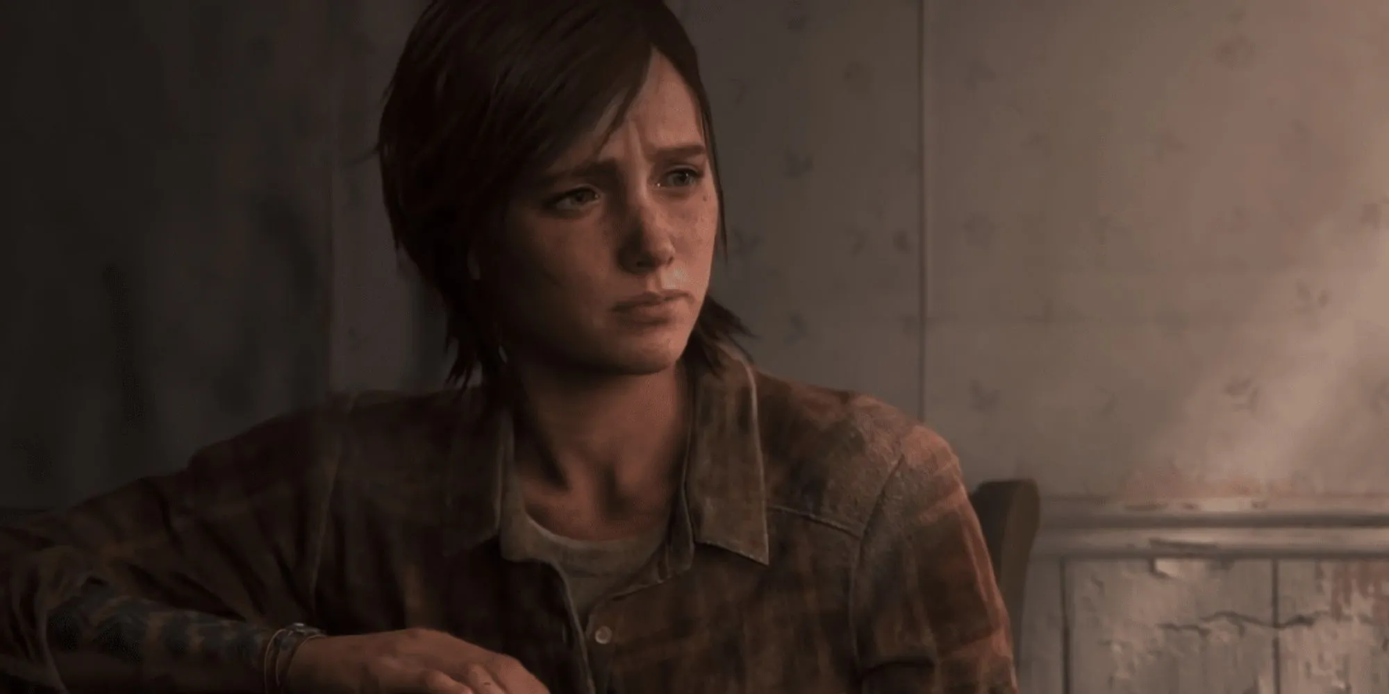 Ellie ngồi một mình bên bờ biển trong The Last of Us Part 2, phản ánh sự mất mát và cái giá của sự trả thù