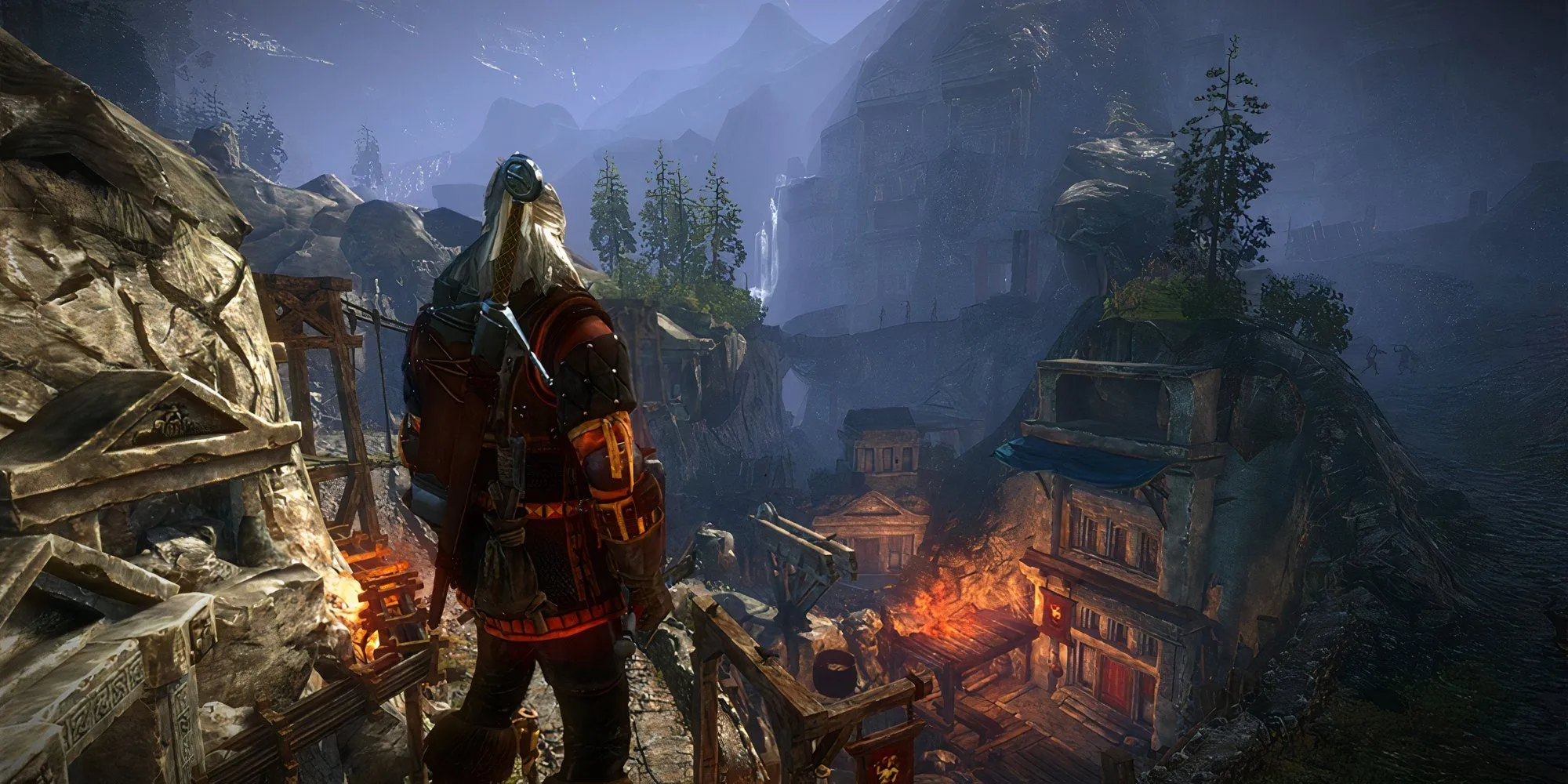 Geralt xứ Rivia nhìn xuống một thị trấn từ trên cao trong The Witcher 2