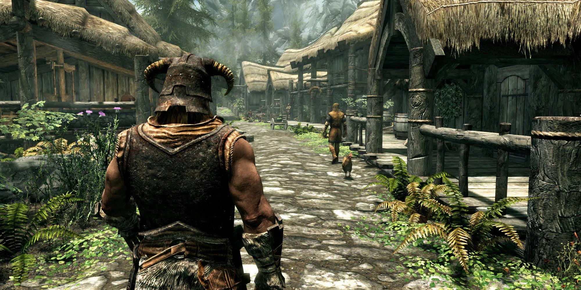 Nhân vật chính trong The Elder Scrolls V: Skyrim nhìn từ phía sau, đứng giữa khung cảnh nhà cửa
