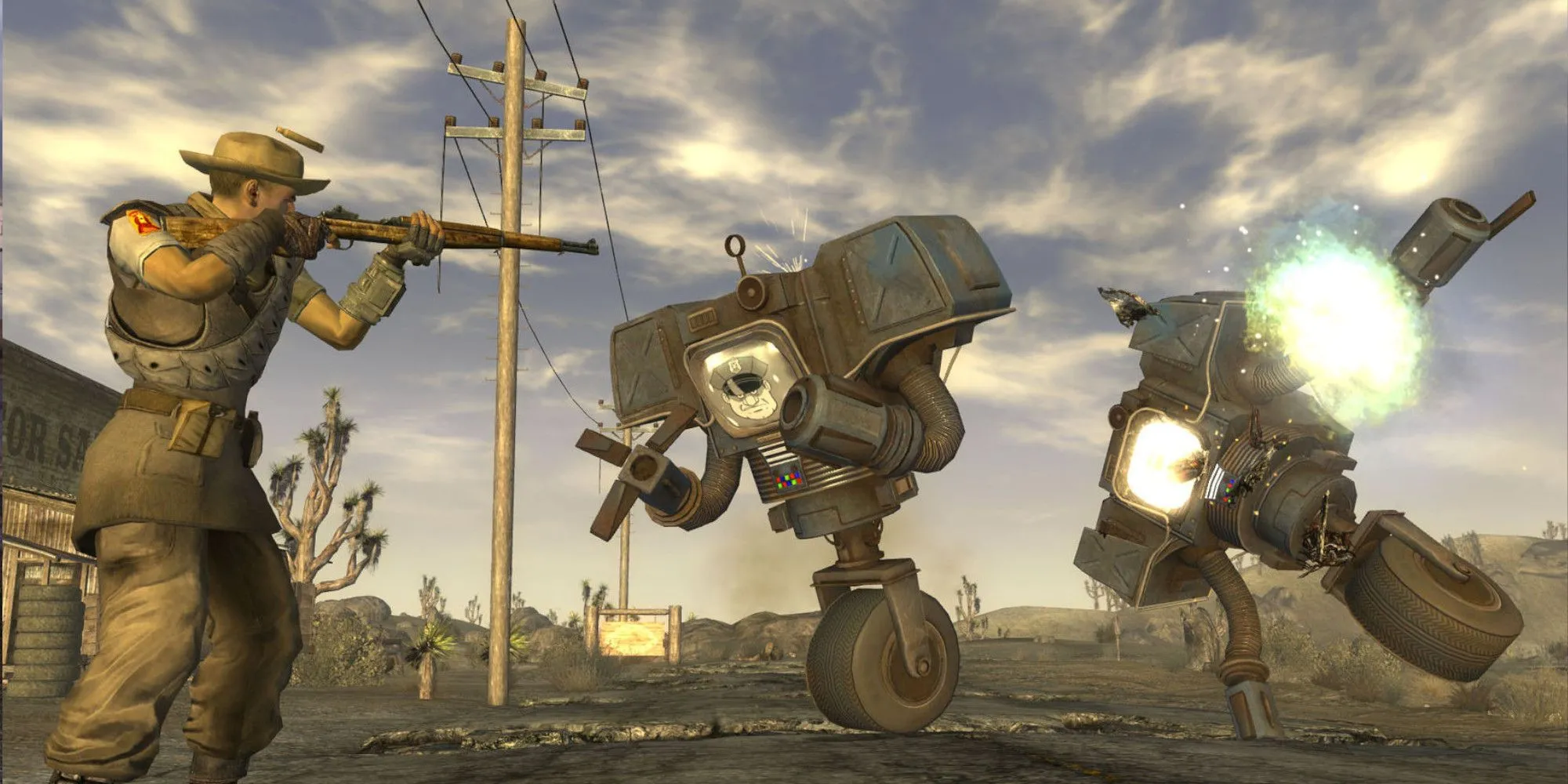 Nhân vật Fallout New Vegas chĩa vũ khí vào đám robot tại vùng đất hoang tàn