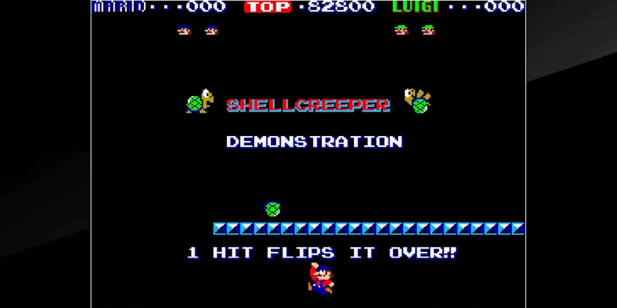 Ảnh chụp màn hình game Mario Bros trên máy arcade với hai anh em Mario và Luigi đang nhảy trên các tầng gạch, có một kẻ địch mai rùa bên dưới.